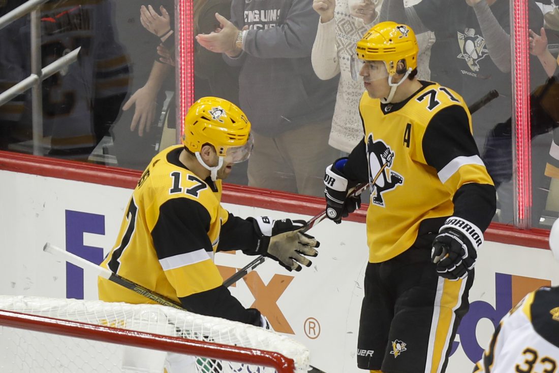 Pittsburgh Penguins' Dominik Simon, left, celebrates a goal by